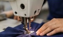 Tailor stitching school uniform